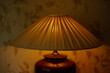 Pleating lampshade with warm light in dark room, closeup.