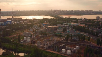 Wall Mural - Sunset over European city industrial zone with factories, aerial panorama