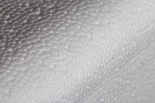 Simple Close-up Bumpy Background Of White Polystyrene Foam Or Styrofoam, White On White Backdrop With Selective Focus And Partial Blur.