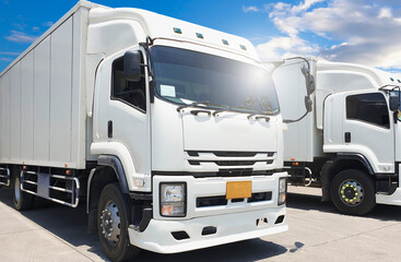 White cantainer shipping truck on parking. Road freight cargo industry logistics and transportation.