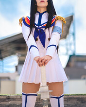 Girl With Craft Made Anime Cosplay Of White Uniform In The Rooftop Of A Building Under The Blue Sky