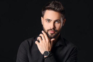 Stylish young man on dark background