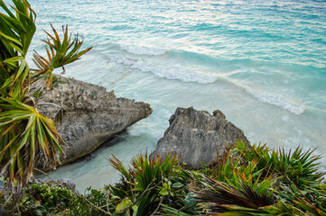 Wall Mural - It's Stones on the coast with the blue waves coming to the sand