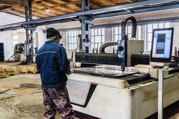 The operator of the CNC laser machine at work. Photo taken at the factory floor