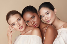Beauty. Group Of Diversity Models Portrait. Multi-Ethnic Women With Different Skin Types Posing On Beige Background. Tender Multicultural Girls Standing Together And Looking At Camera.