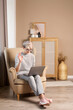 © dariazu - Smart woman about 30s in casual clothes communicating via video call on a laptop