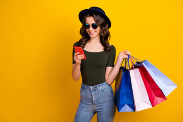 Sticker - Portrait of her she nice attractive lovely fashionable cheerful wavy-haired girl carrying new things using cell ordering home delivery isolated on bright vivid shine vibrant yellow color background