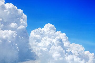 Wall Mural - White cumulus clouds on clear blue sky background close up, beautiful aerial cloudscape view, azure skies backdrop, fluffy cloud texture, sunny heaven, cloudy weather, cloudiness landscape, copy space