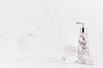 Wall Mural - Elegant soap dispenser, white fluffy towel and cream with lavender in elegant white bathroom interior with copy space.