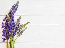 Flowers Composition. Frame Made Of Purple Flowers On Ivory Color Background With Horizontal Boards. Flat Lay, Top View, Copy Space.