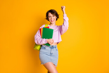 Poster - Portrait of her she nice attractive lovely successful smart clever cheerful cheery glad girl holding in hand materials celebrating a-mark isolated on bright vivid shine vibrant yellow color background