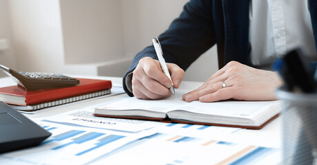 Cropped view of businessman works with financial papers at the table. Finance concept