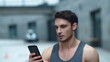 © stockbusters - Closeup athlete man looking smartphone on street. Smiling man reading message