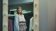 Attractive female customer is choosing skirt in fitting room