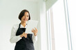 © chinnarach - close up young business owner using tablet to checking order and answering from online customer in restaurant bar shop for modern business and technology lifestyle concept