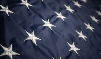 White American stars on usa flag. Selective focus in foreground. Abstract pattern or background with usa flag. Macro or close up shot. Patriotic concept.