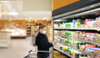 © lado2016 - Supermarket shopping, face mask and gloves,Woman choosing a dairy products at supermarket