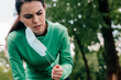 © LIGHTFIELD STUDIOS - Young sportswoman taking off medical mask in park