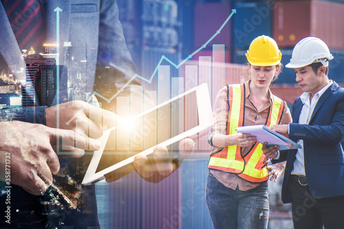Fotomural Businessman use tablet show growth revenue graph info and engineer partner stand at container yard, loading containers box from cargo freight ship for import and export, teamwork partnership concept