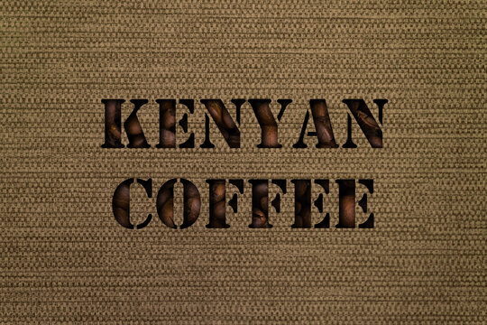 Varieties of Kenyan coffee text made up of coffee beans on a background of canvas fabric