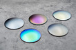 © Arsenii - Close up of optical lenses for sunglasses with different color. Production and adjust of new eyeglasses lens in optics. Eyesight concept