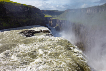 View from center of Gullfoss waterfall on the Hvítá river, a popular tourist attraction and part of the Golden Circle Tourist Route in Southwest Iceland. Golden Waterfall