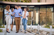 © luckybusiness - group of colleagues  walking and talking in front of business building