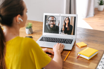 Video call of multiracial team. A young woman is talking online with coworkers, friends