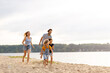 © pikselstock - Young family enjoying time at the beach