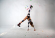 © константин константи - beautiful brunette girl in a robot suit takes gymnastic poses on a white background
