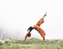 Yoga On Nature. Young Woman Is Practicing Yoga In Mountains