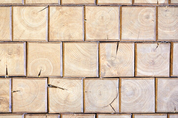 Wooden brick wall. Natural wood texture of square shape. Mosaic of bars. Vintage, abstract pattern. Old retro floor. Dark surface of squares. Rustic style.