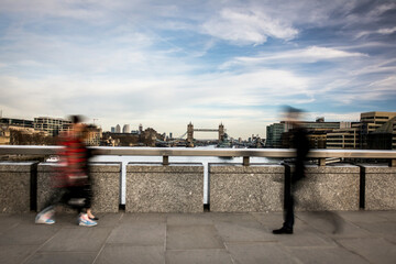 Canvas Print - Motion blurred people walking with London River thames scene in background 