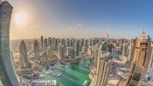Sunrise Over Dubai Marina Skyscrapers And Jumeirah Lake Towers Panoramic View From The Top Aerial Morning Timelapse In The United Arab Emirates. Floating Yachts And Boats