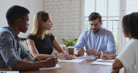 Canvas Print - Male boss ceo executive talk to diverse people explain corporate strategy at company briefing, multiracial workers group listen businessman team leader instructing staff sit at meeting office table