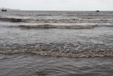 Fototapeta Do pokoju - Waves of ocean water during the low tide. Oil spill in the sea.