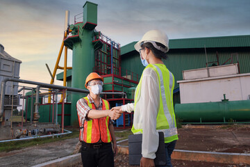 Wall Mural - Construction engineers supervising progress of construction project stand on new factory,Engineering Consulting People on construction site holding blueprint in his hand. Building inspector. 