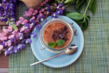 Canvas Print - Coffee and tiramisu on the table on the veranda of the coffee shop