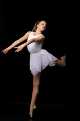 Wall Mural - Full length portrait of a charming gymnast girl in elegant dress.