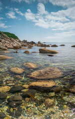 Poster - View of the seashore with large stones and marine life under water