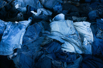 Stack of various shades blue jeans. Pile Blue denim jeans texture banner. Canvas denim fashion texture