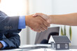 © Puwasit Inyavileart - Asian businessmen shake hands to celebrate in the office.
