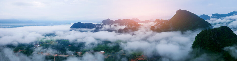 Wall Mural - panorama misty landscape that floats over the mountains and the morning sun.