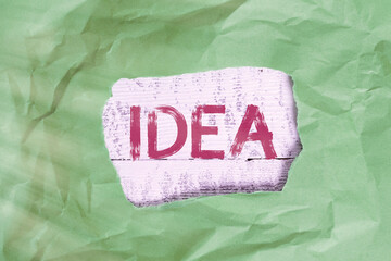 Poster - Conceptual hand writing showing Idea. Concept meaning impression that tries to portray the overarching scope or outline Green crumpled colored paper sheet torn colorful background