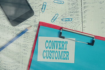 Poster - Handwriting text writing Convert Customer. Conceptual photo marketing tactics and strategy turning leads into buyer Clipboard paper sheet pencil note clips smartphone old wooden background