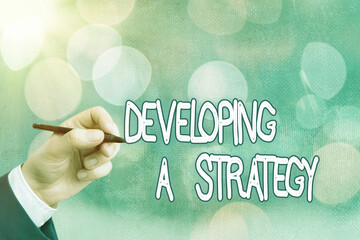 Poster - Conceptual hand writing showing Developing A Strategy. Concept meaning Discussing the Ideas for New Goal Marketing Vision Planning Business