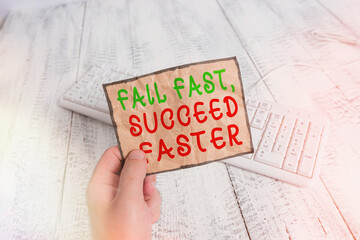 Poster - Conceptual hand writing showing Fail Fast, Succeed Faster. Concept meaning failed attempt increases an eventual success Man holding colorful reminder square shaped paper wood floor