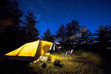 Family tent on camping ground under stars