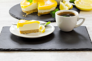  Creamy cheesecake, delicious lemon cheesecake and cup of coffee closeup 