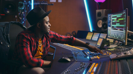 Poster - Stylish Audio Engineer Working in Music Recording Studio, Uses Mixing Board and Software to Create Modern Hit Song. Creative Black Artist Musician Working on Desk Control Surface to Produce New Song